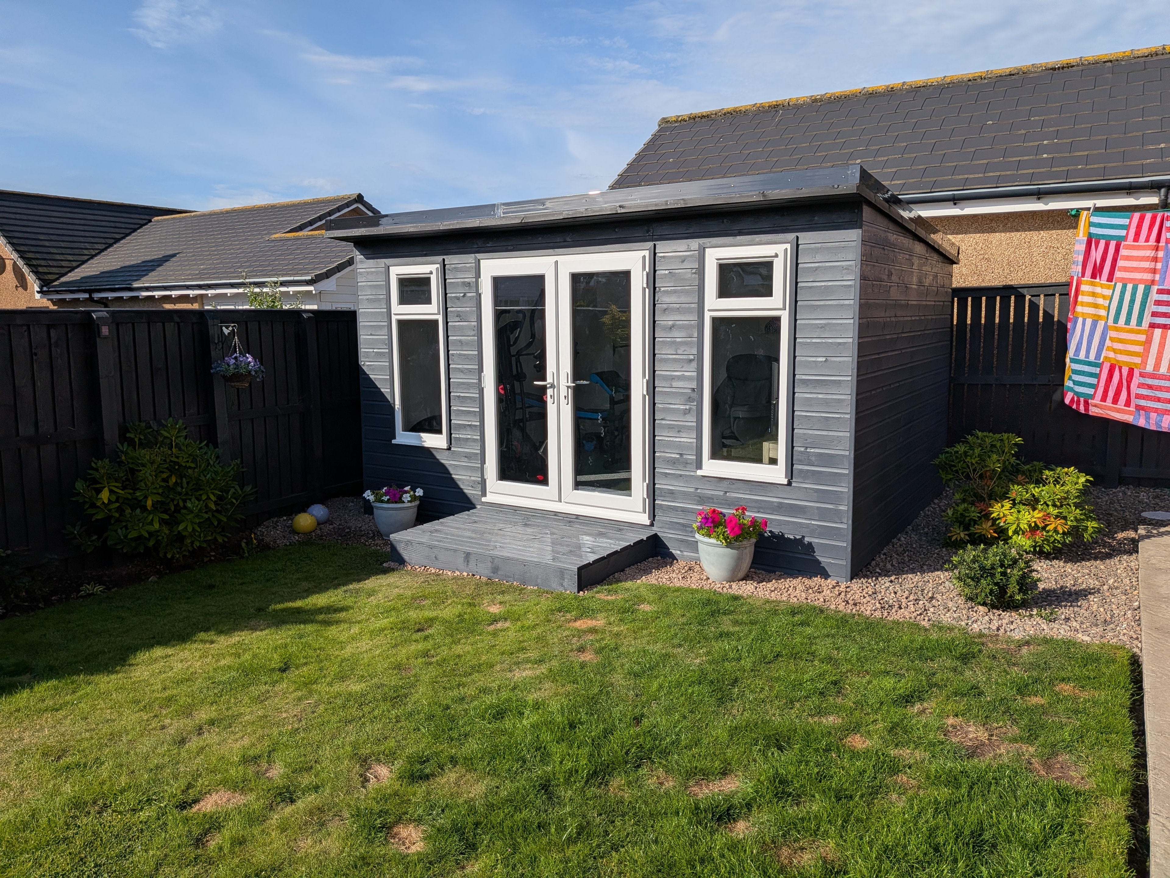 Grey painted garden room with French doors and step
